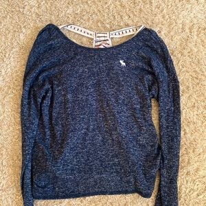 Blue long sleeve tee with inside shirt of black and white stripes.